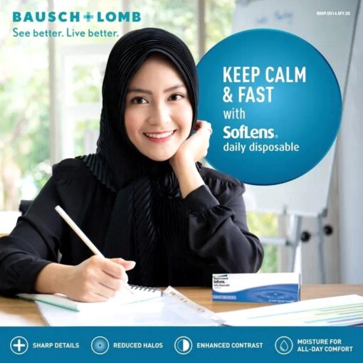 A woman sitting at a desk writing wearing Bausch & Lomb SofLens Daily Lenses